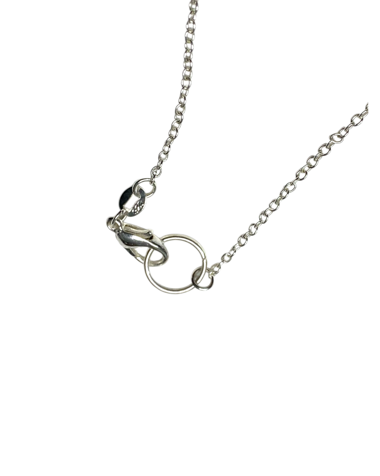 Silver necklace with a clasp on a white background
