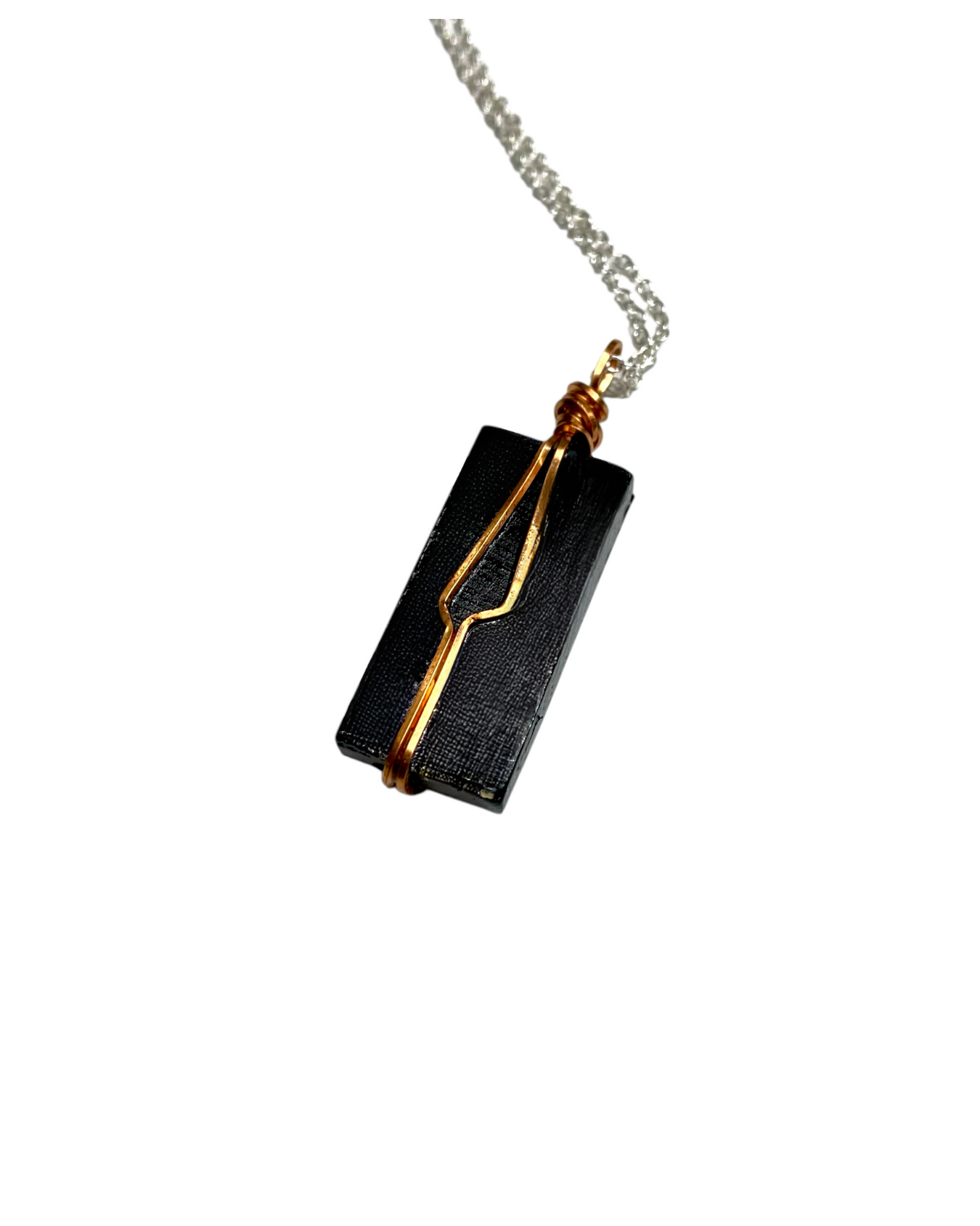 Black rectangular pendant with gold accents on a silver chain against a white background