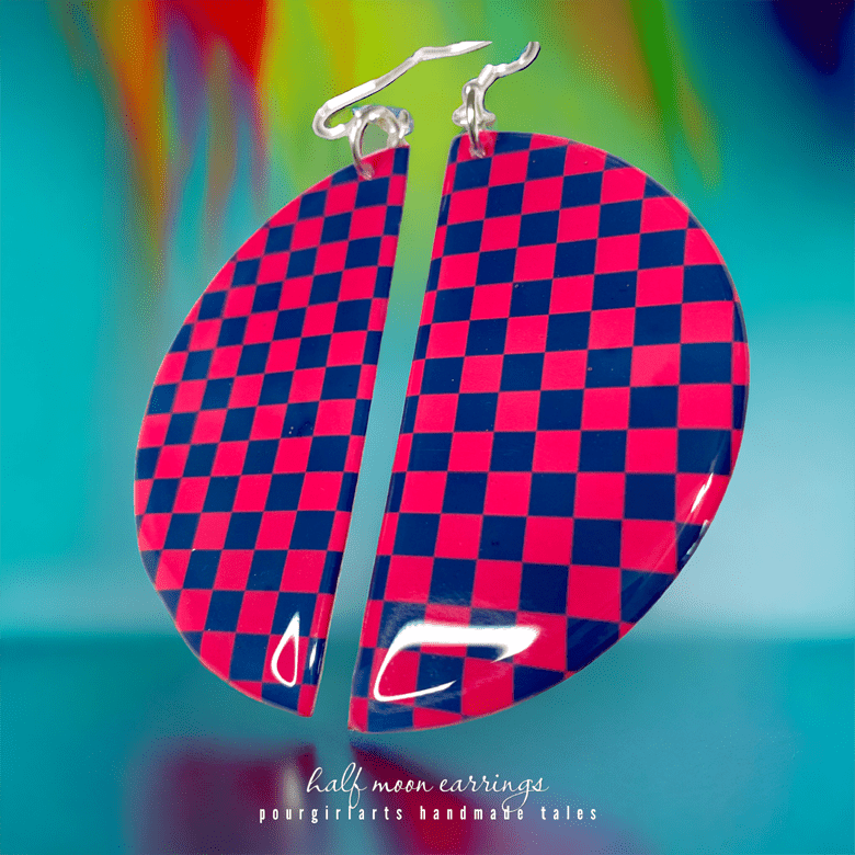 Checkered red and blue earrings on a colorful background