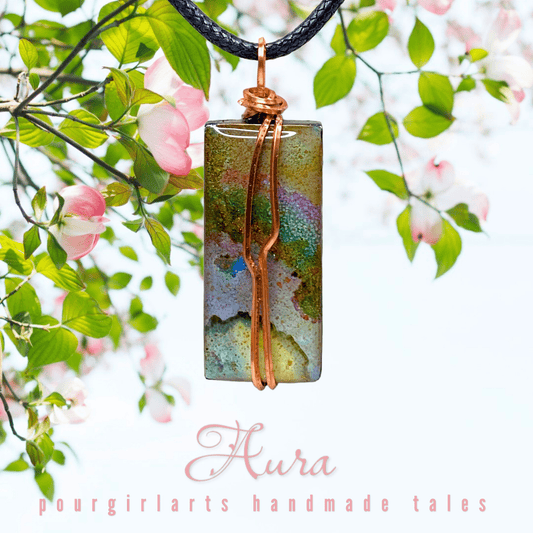 Colorful pendant necklace with 'Aura' branding against a natural background