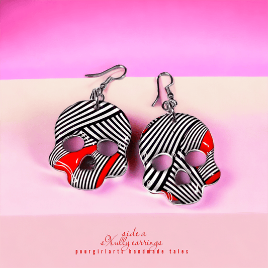Black and white striped earrings with red accents on a pink background