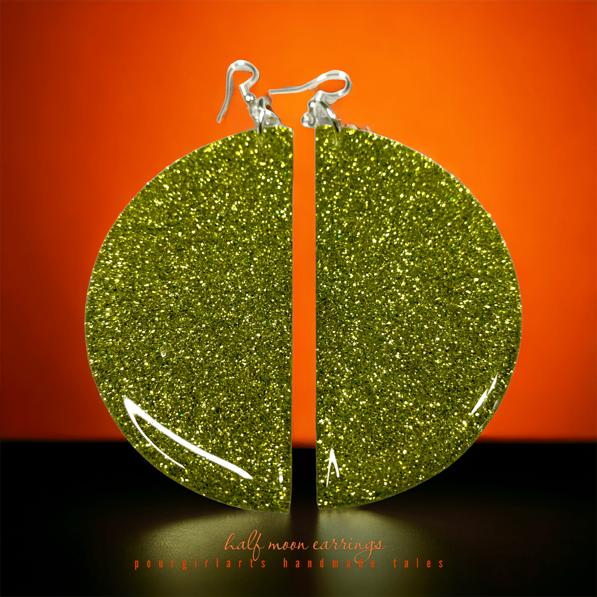 Green glittery earring on an orange background