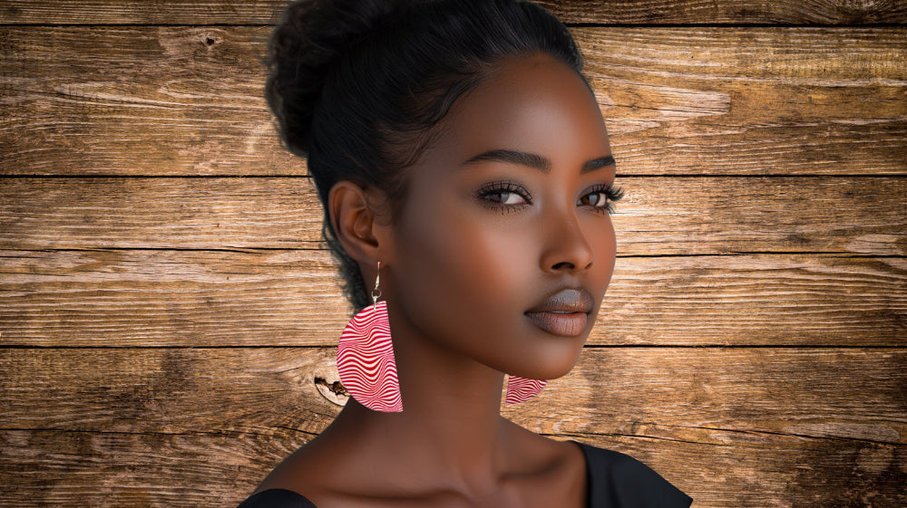 Woman wearing large pink earrings against a wooden background