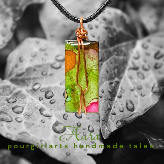 Necklace with a rectangular pendant on a leaf background, featuring the brand 'Hara pourgirlarts handmade tales'.