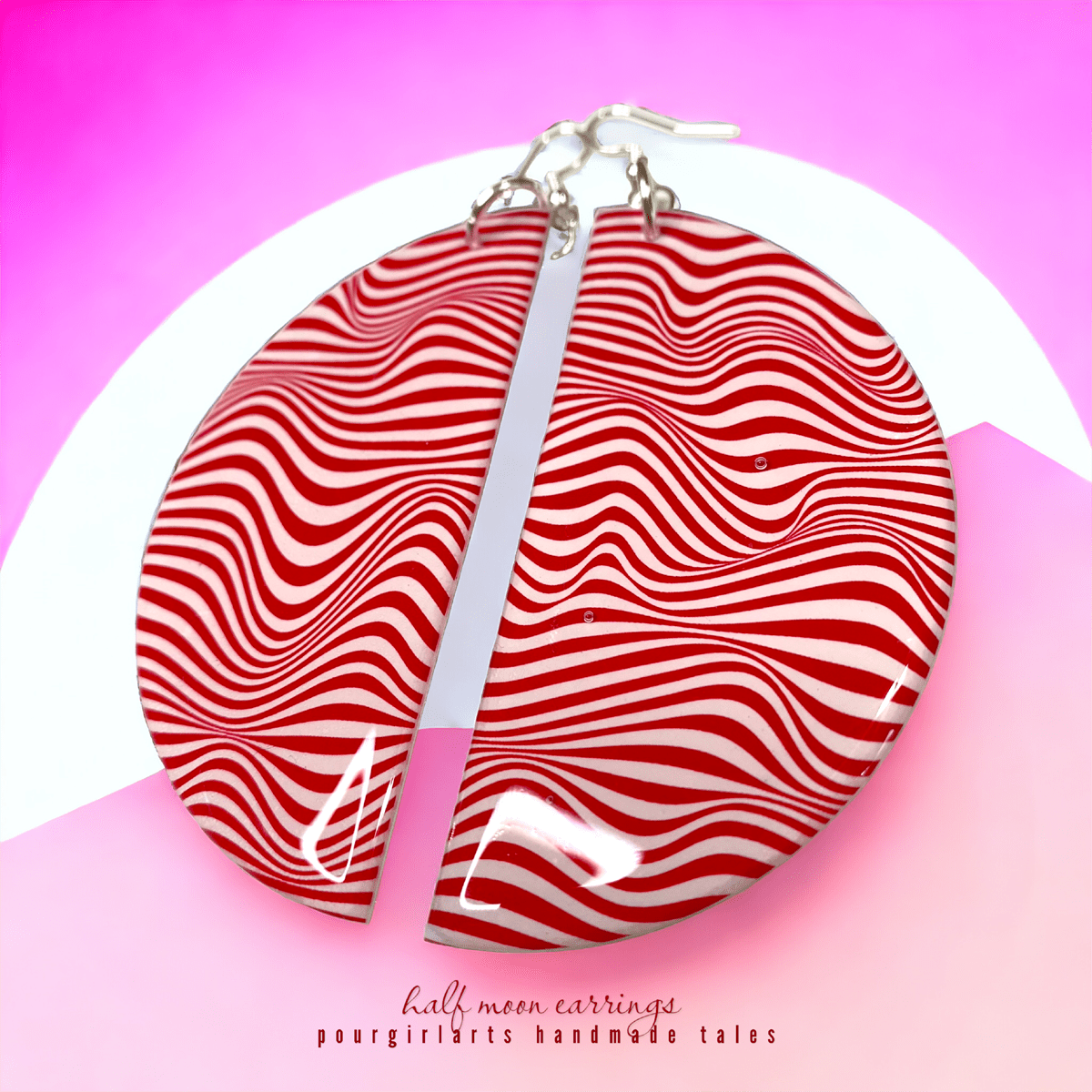 Red and white striped earrings on a pink background with 'half moon earrings' branding.