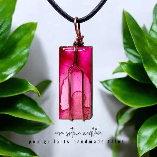 Pink pendant necklace with green leaves in the background
