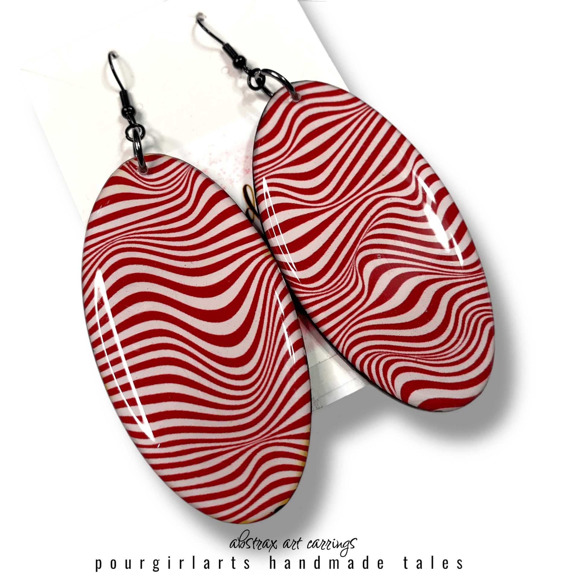Red and white striped earrings on a white background with 'pourgirlarts' branding.