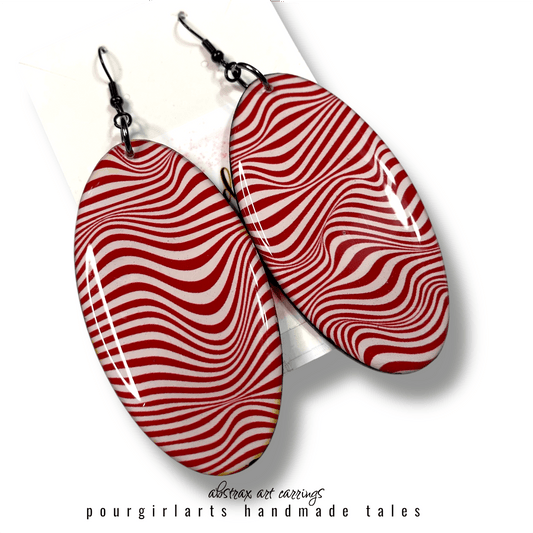 Red and white striped earrings on a white background with 'pourgirlarts' branding.