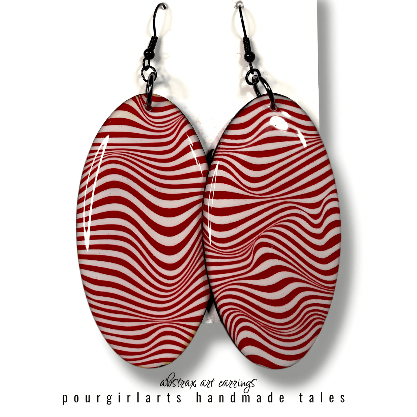 Red and white striped earrings on a white background with 'pourgirlarts' branding.