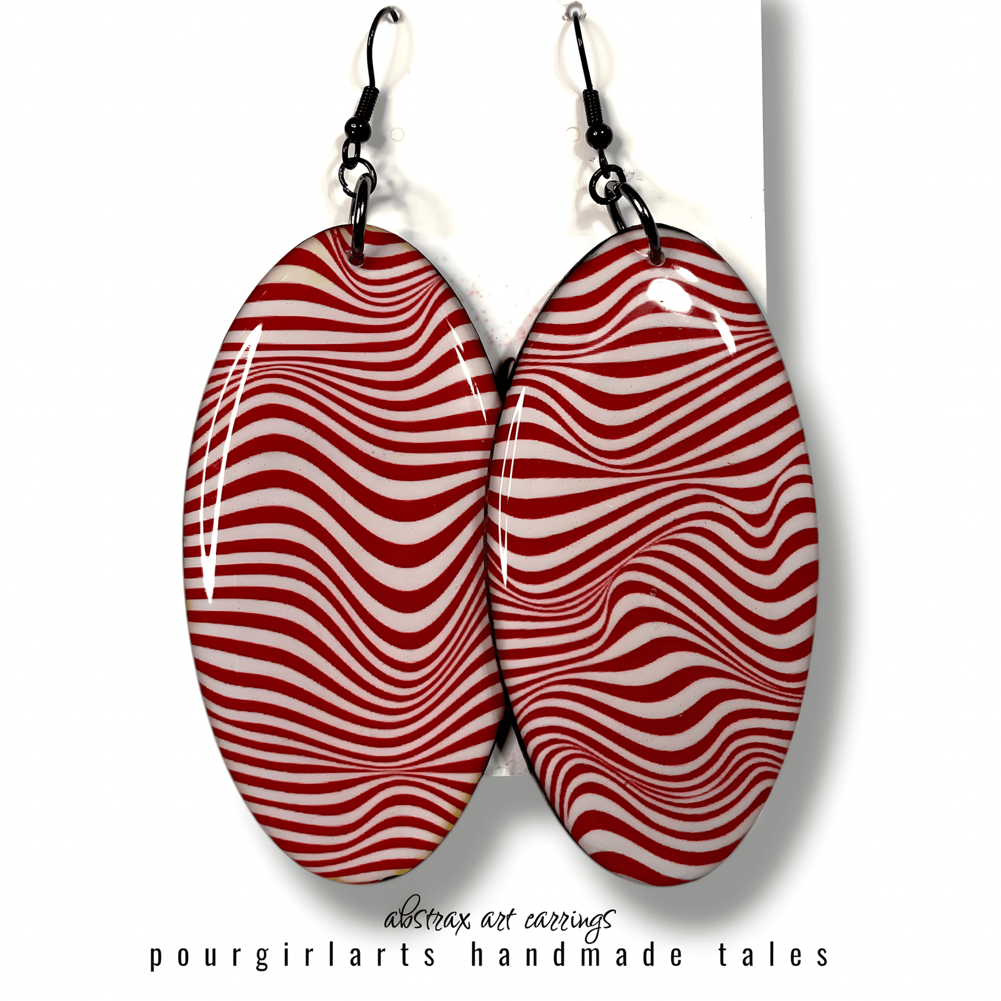 Red and white striped earrings on a white background with 'pourgirlarts' branding.