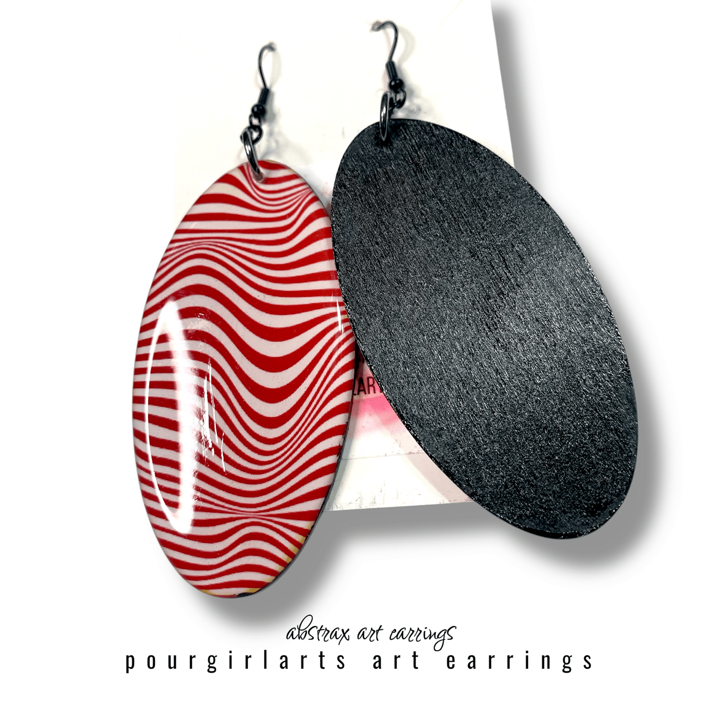 Two earrings, one with red and white striped pattern and the other black, on a white background with 'pourgirlarts' branding.