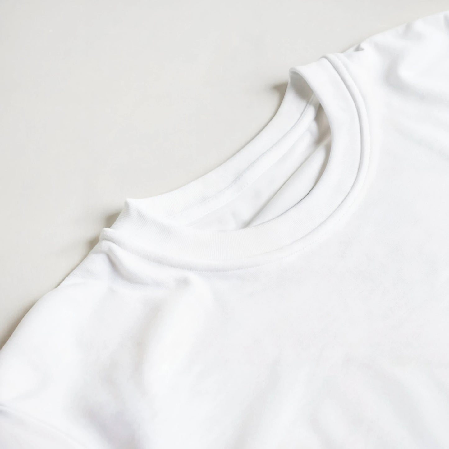 Close-up of a white shirt collar on a light gray background