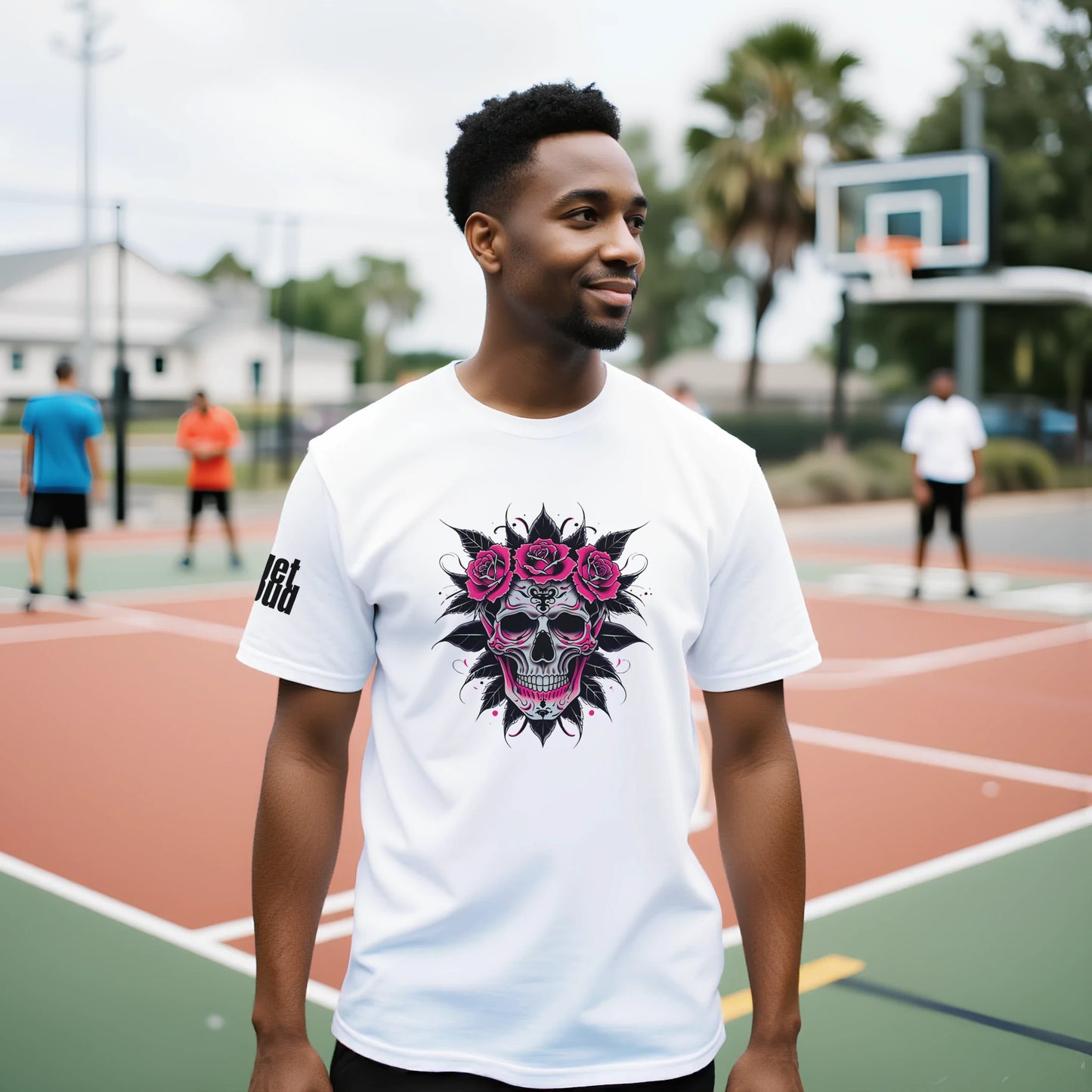 Man wearing a white t-shirt with a colorful skull design on a basketball court.