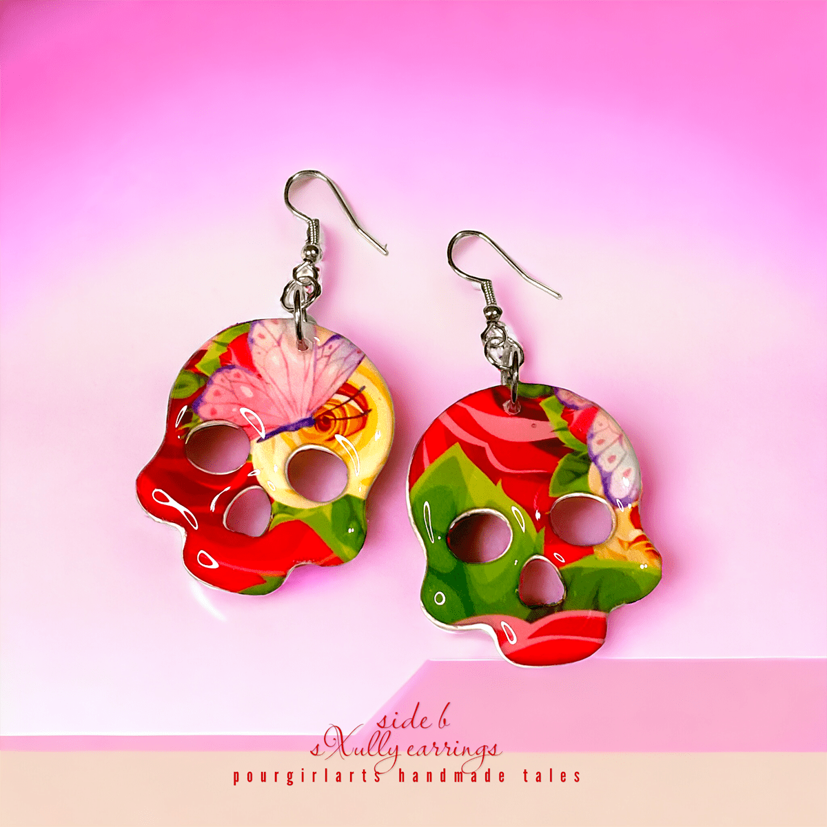 Colorful butterfly-themed earrings on a pink background with 'side b' branding.