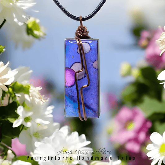 Rectangular pendant necklace with floral design against a blurred floral background