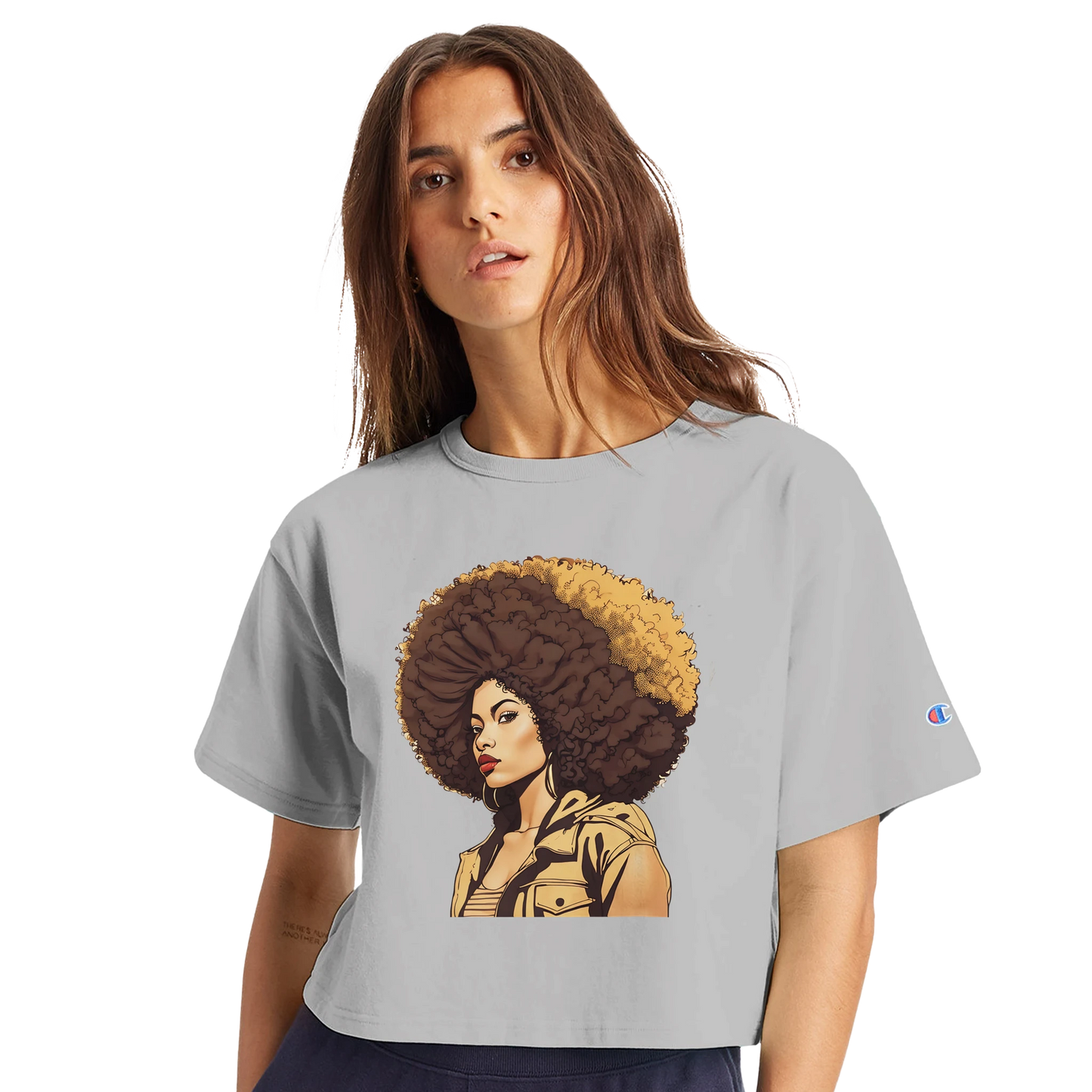 Woman wearing a gray t-shirt with a graphic of a woman with an afro on a white background