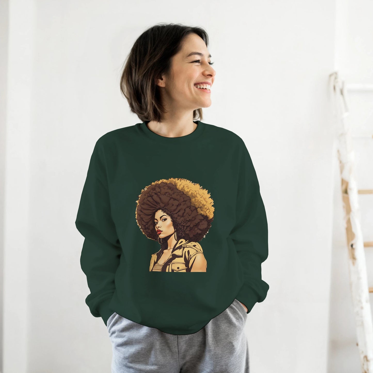 Person wearing a green sweatshirt with a graphic design of a woman with an afro on a white background