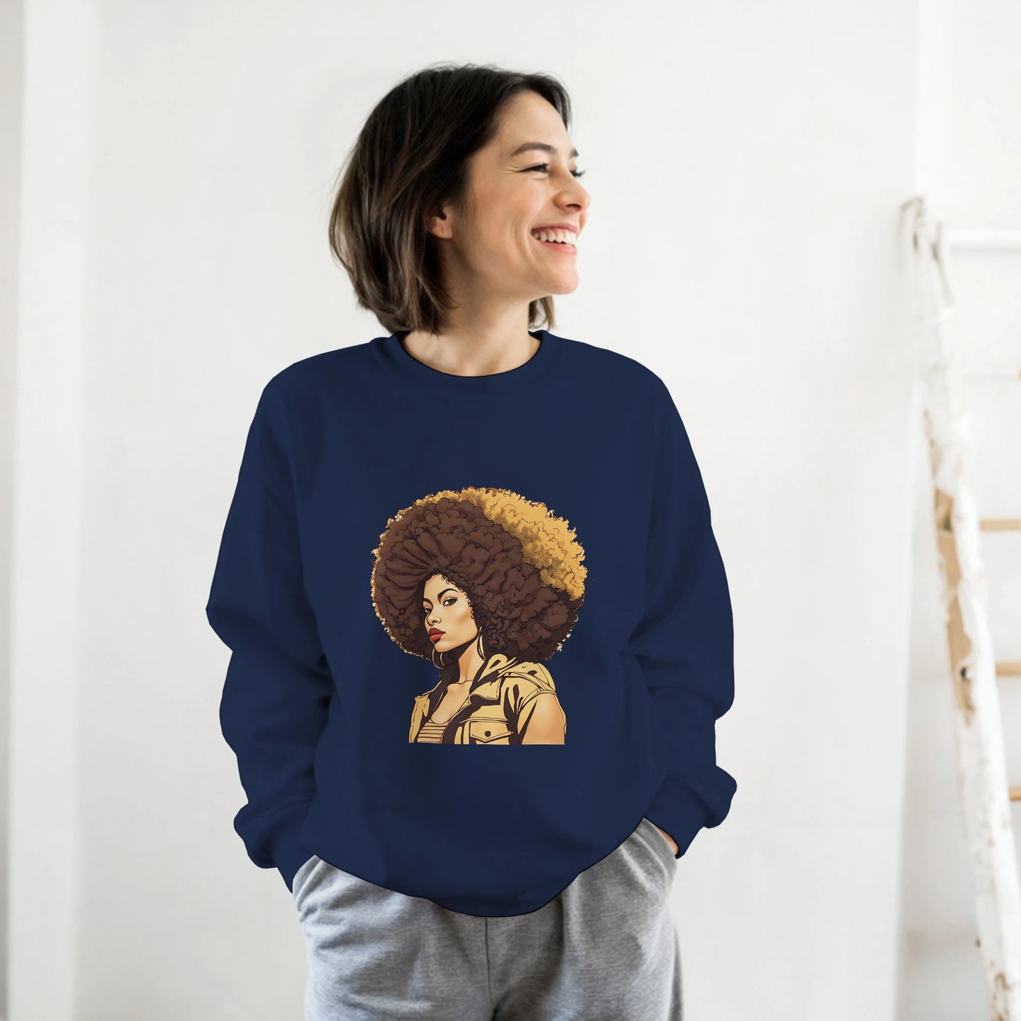 Person wearing a navy blue sweatshirt with a graphic of a woman with an afro on a white background