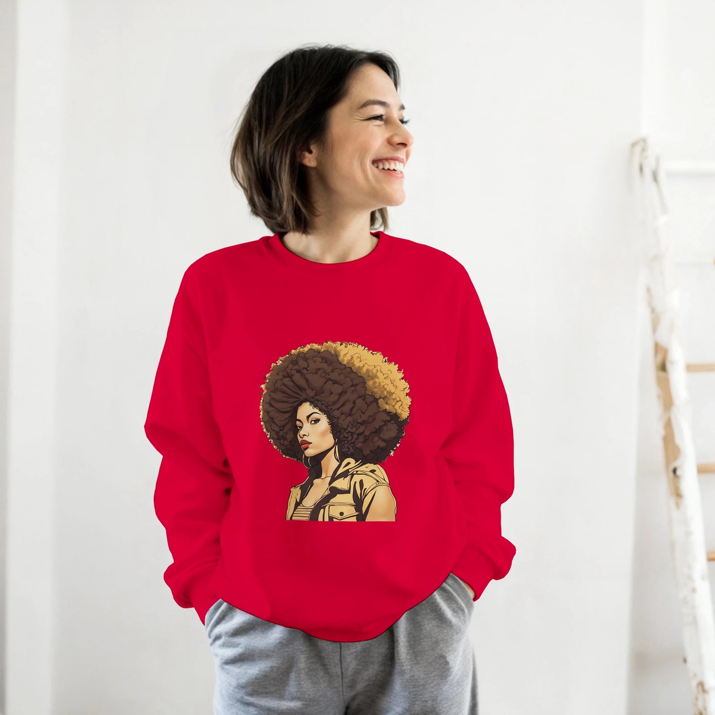Person wearing a red sweatshirt with a graphic design of a woman with an afro on a white background